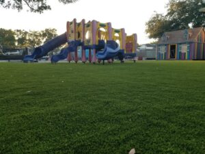 Playground-specific artificial grass